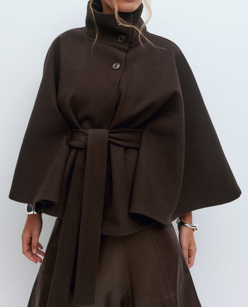 Belted black cape coat with stand collar and button closure, made from wool-style fabric for women, perfect for stylish winter layering. 1