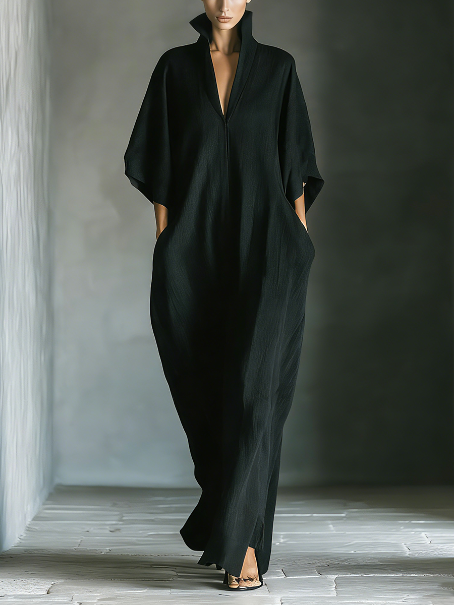 Black maxi dress featuring kimono sleeves and convenient pockets, designed for women in a comfortable oversized cotton blend. 0
