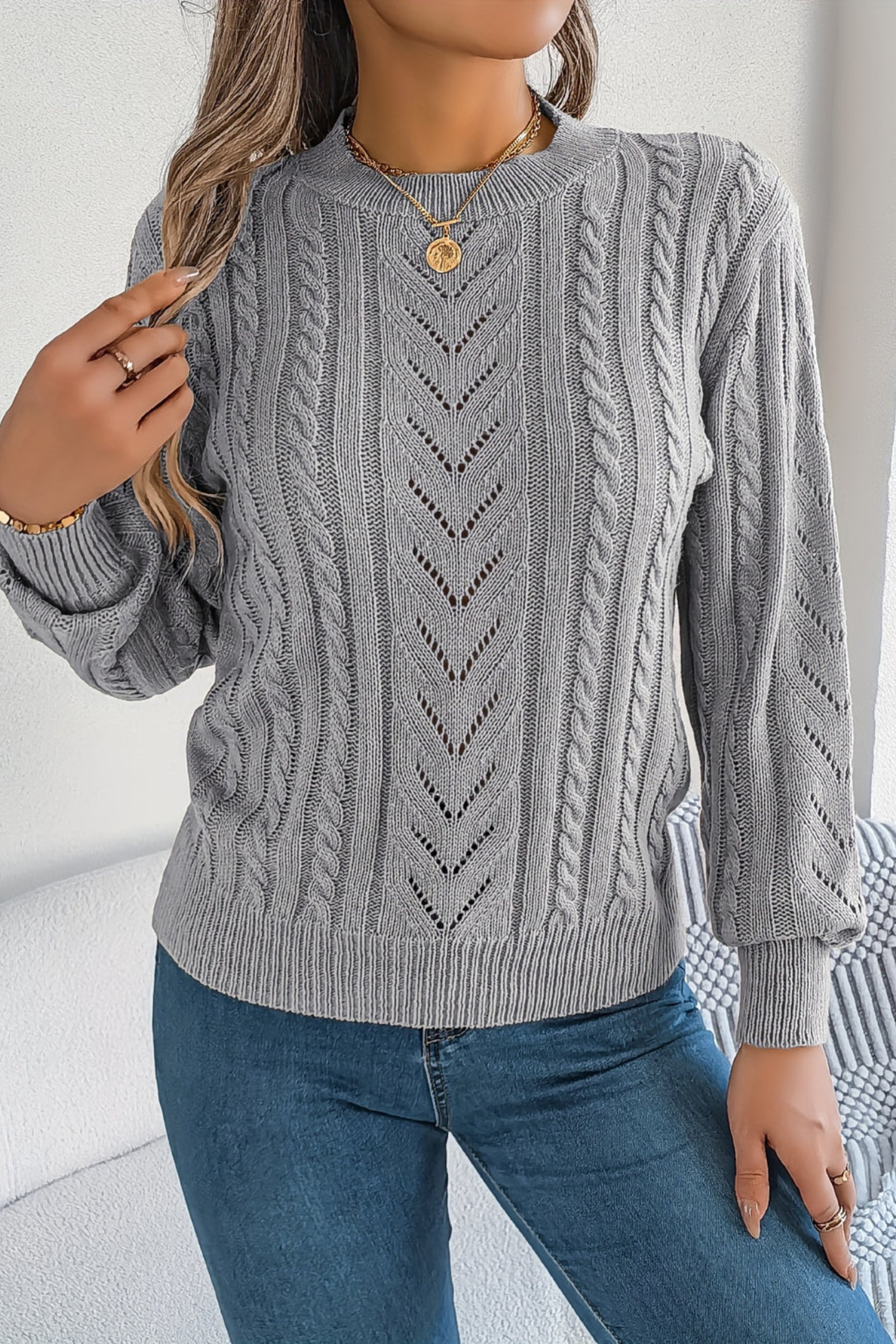 Cozy cable knit sweater for women featuring a stylish chevron pattern and trendy puff sleeves, perfect for fall and winter wear. 3