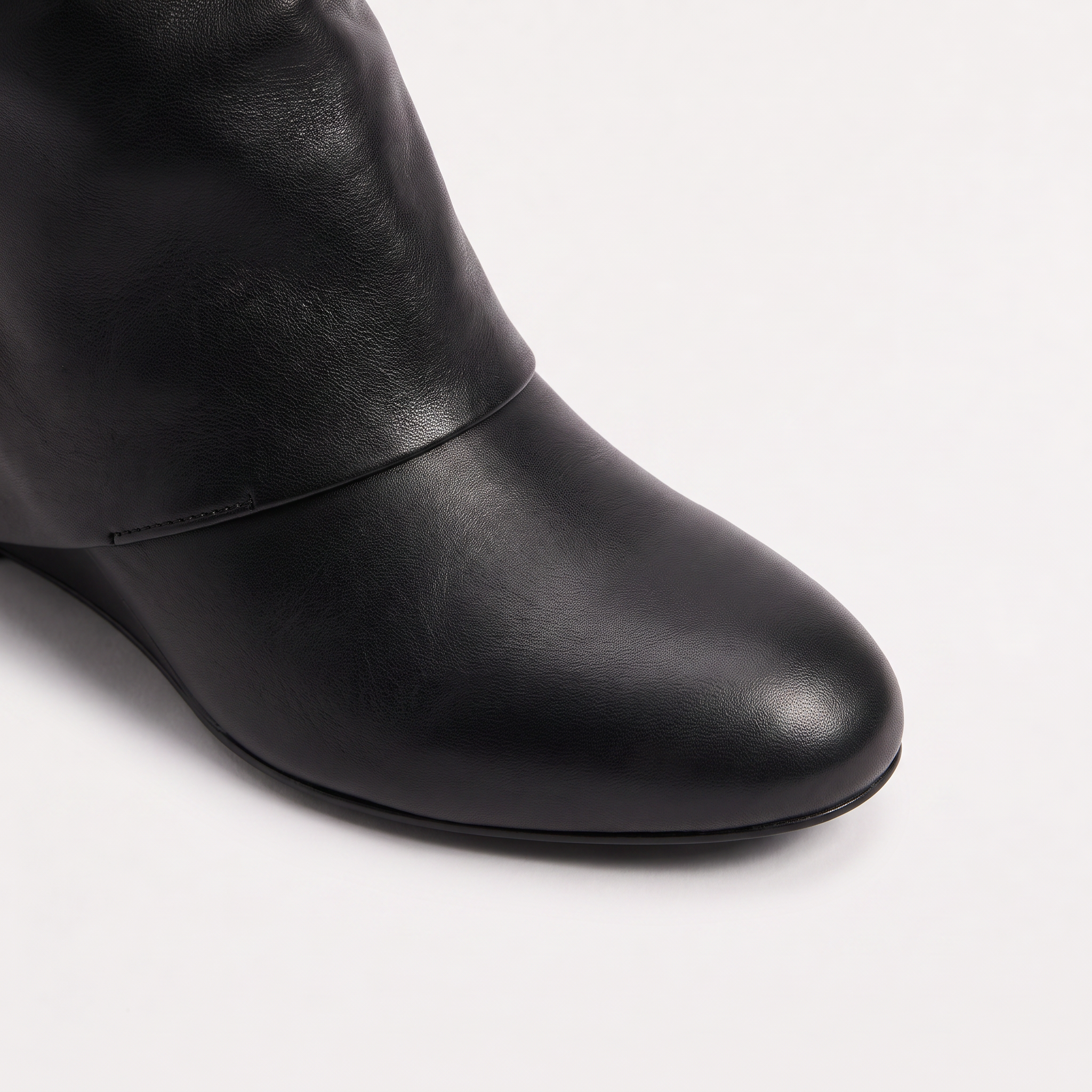 Knee high black boots for women featuring a stylish fold-over cuff and a comfortable low wedge heel, made with vegan upper materials. 2