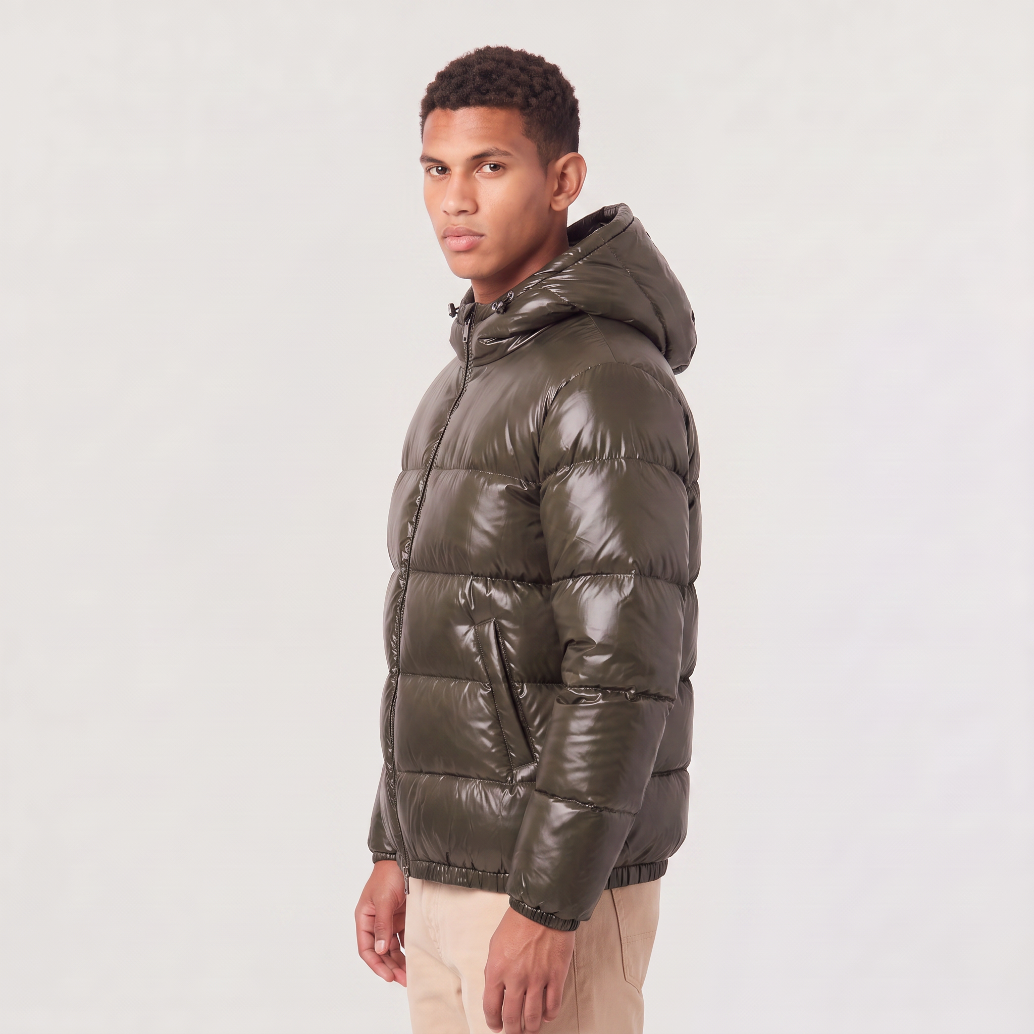 Men's hooded puffer jacket featuring zip pockets and a glossy quilted finish, designed for a relaxed fit, perfect for winter wear. 4