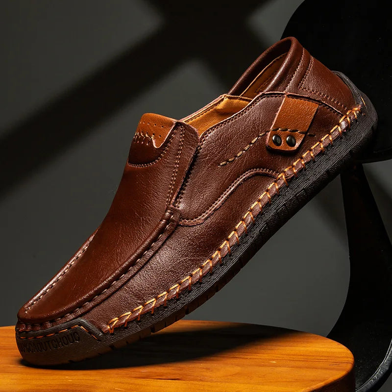 Men's leather slip-on loafers featuring a cushioned insole and a glossy finish, ideal for both casual and formal occasions. 2