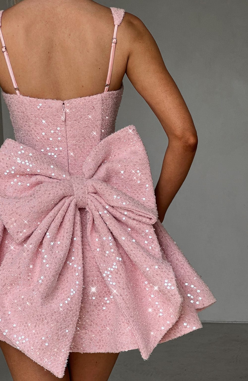 Sequin mini dress with flared skirt and back bow detail, perfect for wedding guests and cocktail parties. 6
