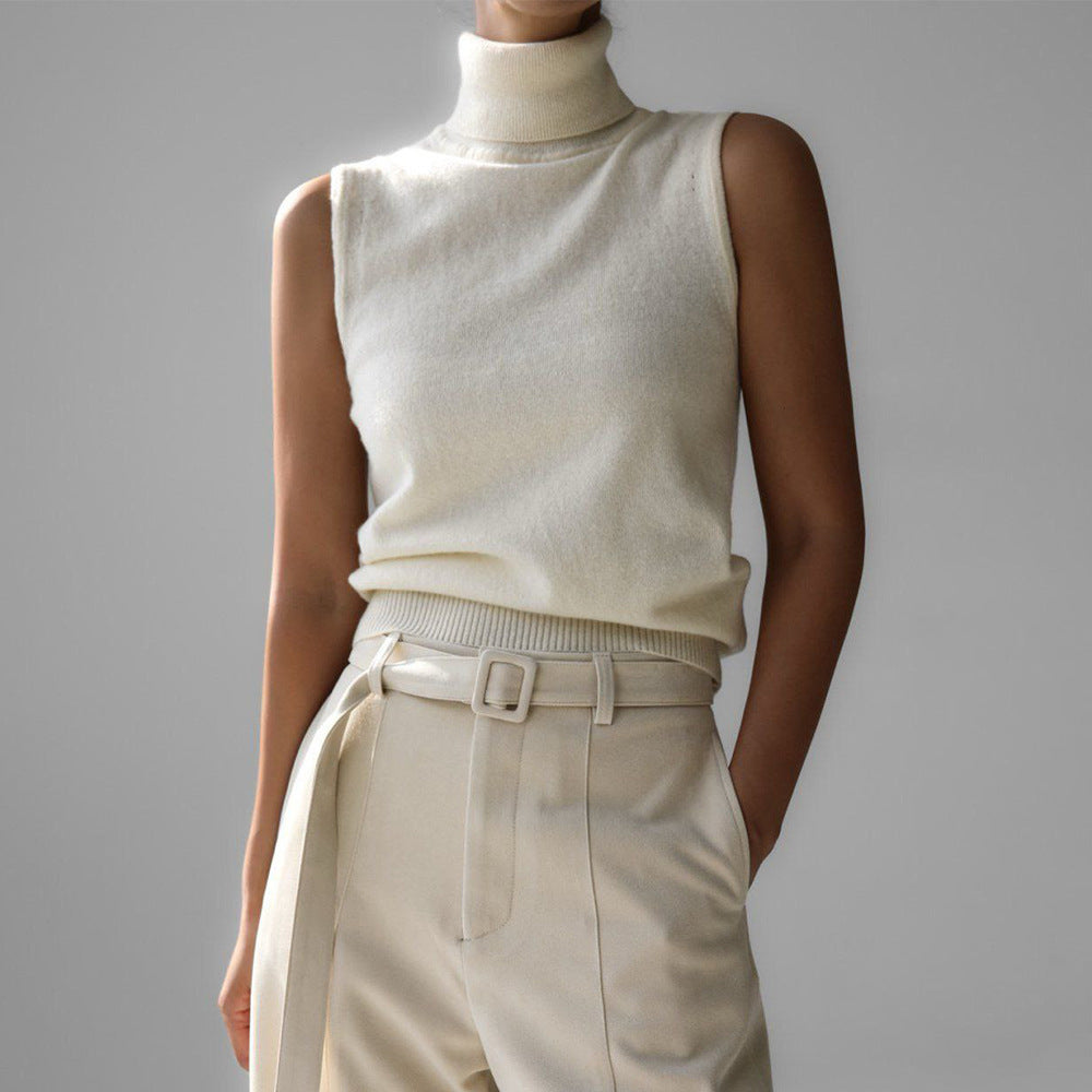 Sleeveless knit top for women featuring a soft turtleneck design and ribbed hem, perfect for layering or wearing alone. 0
