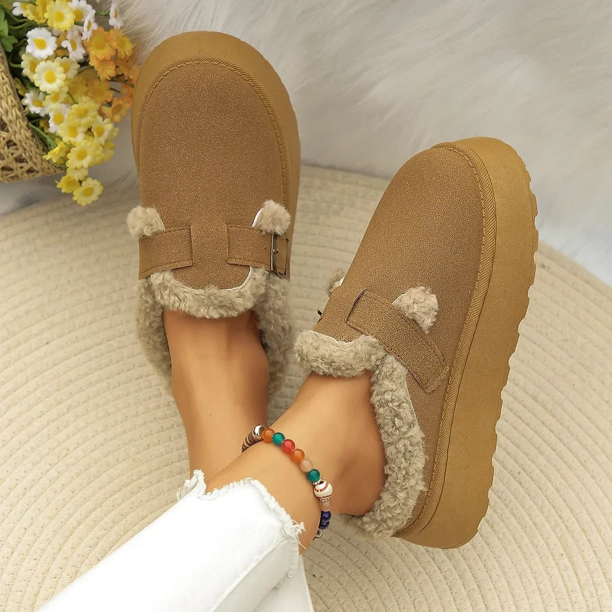 Suede slippers with plush lining and durable sole in brown, black, and white, offering slip-on comfort for indoor use. 1