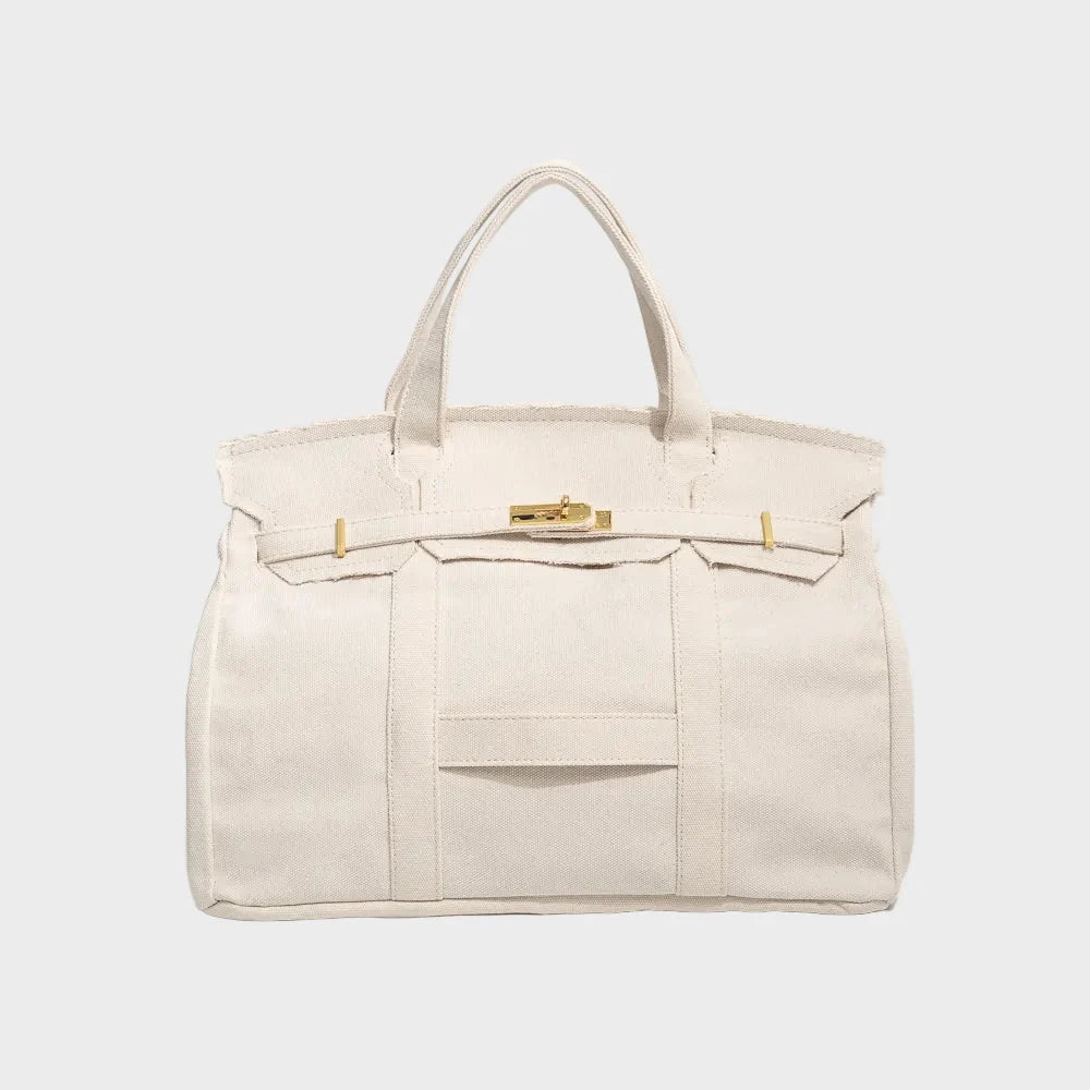 Vintage linen canvas tote bag featuring reinforced handles and a secure snap closure, designed for water resistance and ample space, perfect for everyday use. 5