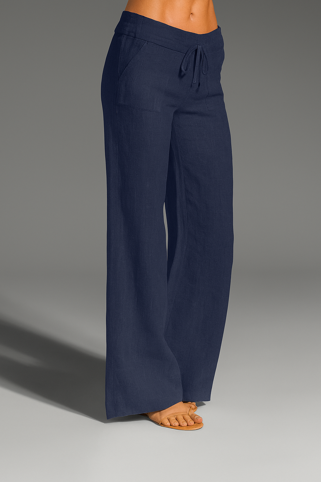 Wide leg linen trousers with drawstring waist, featuring a relaxed fit for women, perfect for casual outings in natural linen fabric. 1