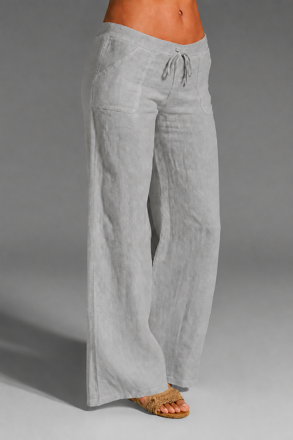 Wide leg linen trousers with drawstring waist, featuring a relaxed fit for women, perfect for casual outings in natural linen fabric. 3