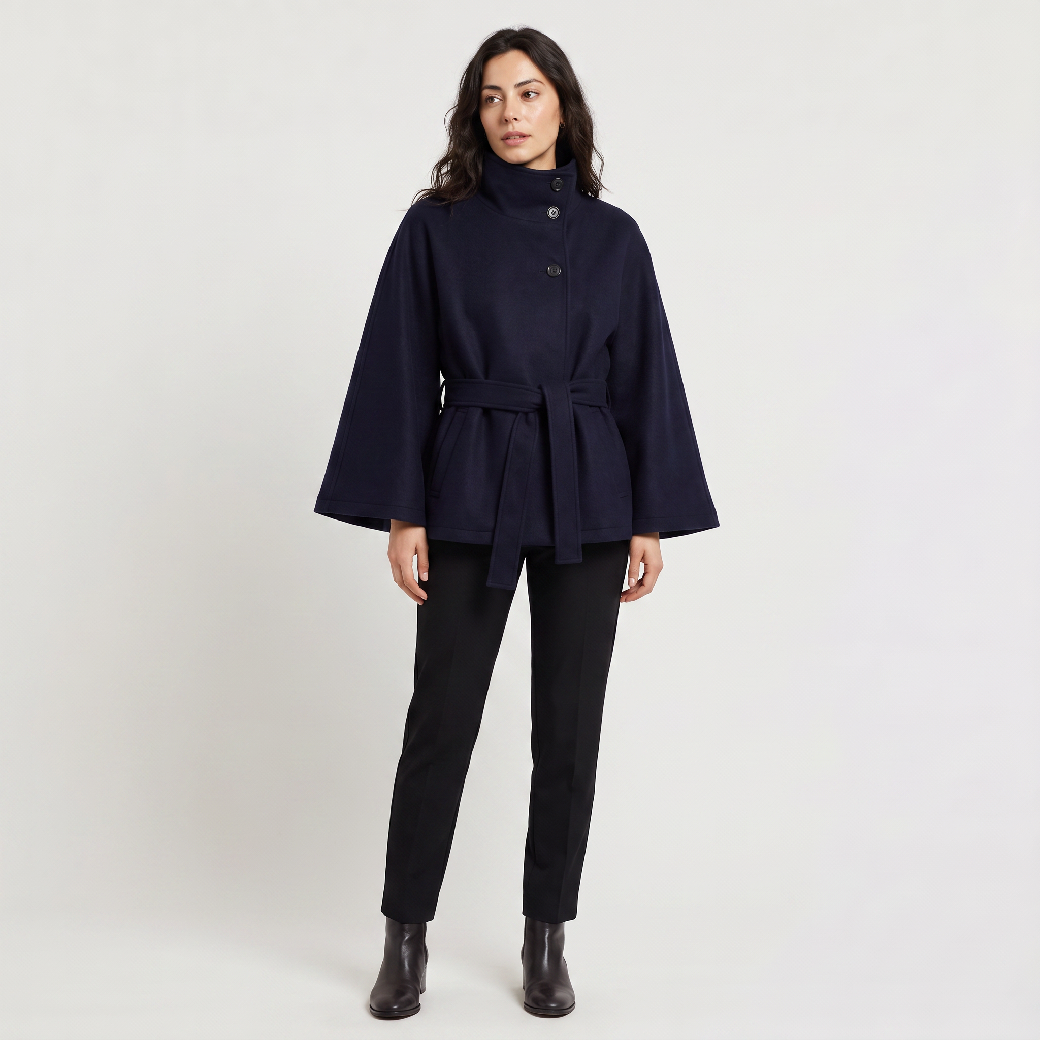 Women's oversized winter coat featuring a high collar and adjustable belt, designed for warmth and style, perfect for cold weather fashion. 2