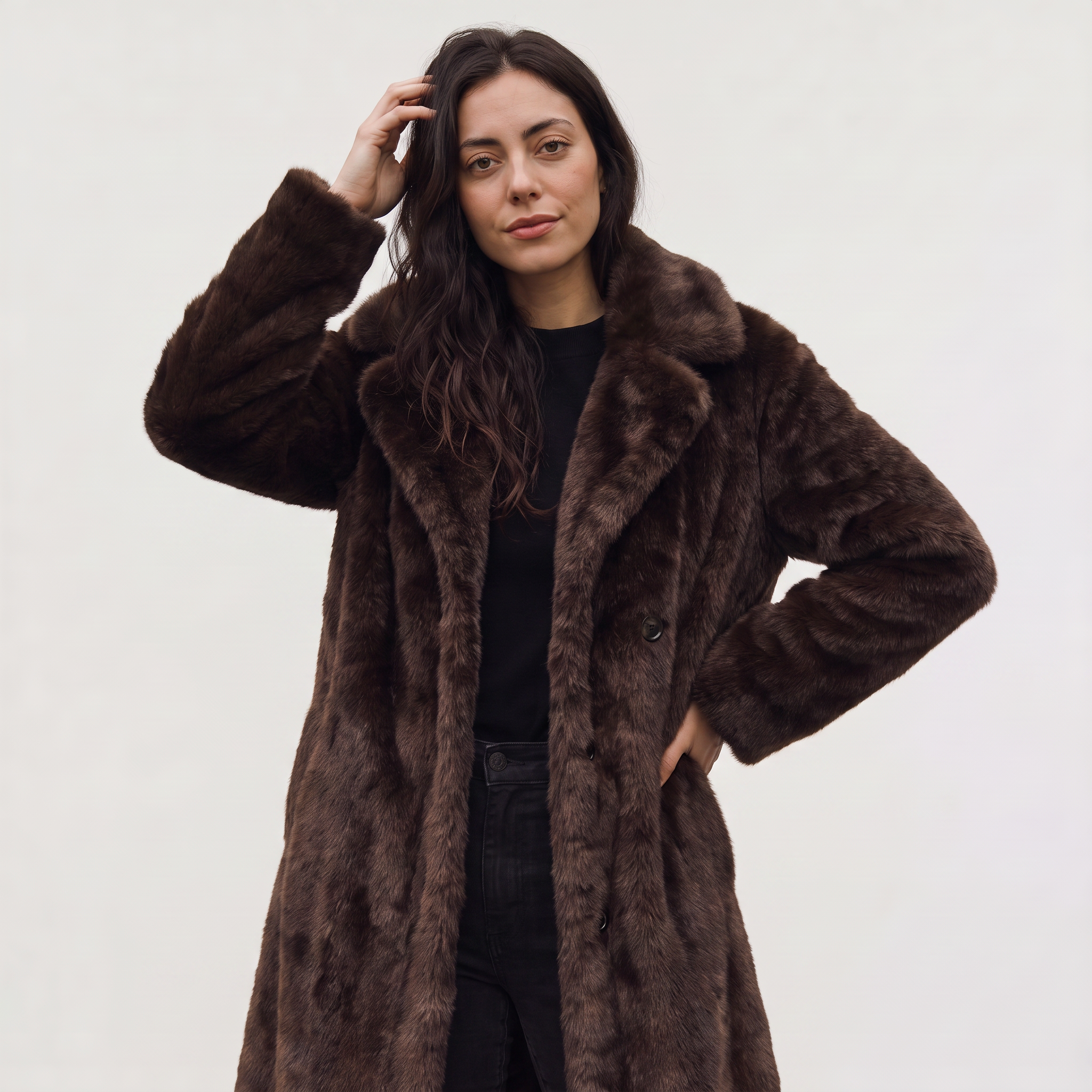 Women's faux fur trench coat featuring double-button fastening, side pockets, and a long relaxed fit, perfect for stylish winter outerwear. 2