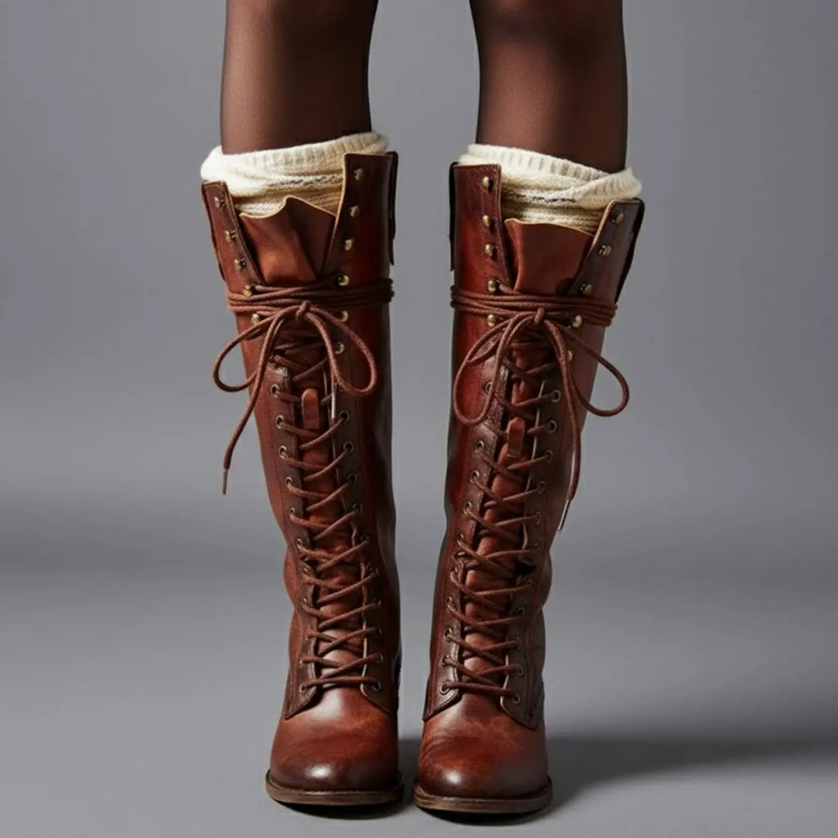 Women's black faux leather knee-high boots featuring a lace-up front, block heel, and stylish stud detail. 9