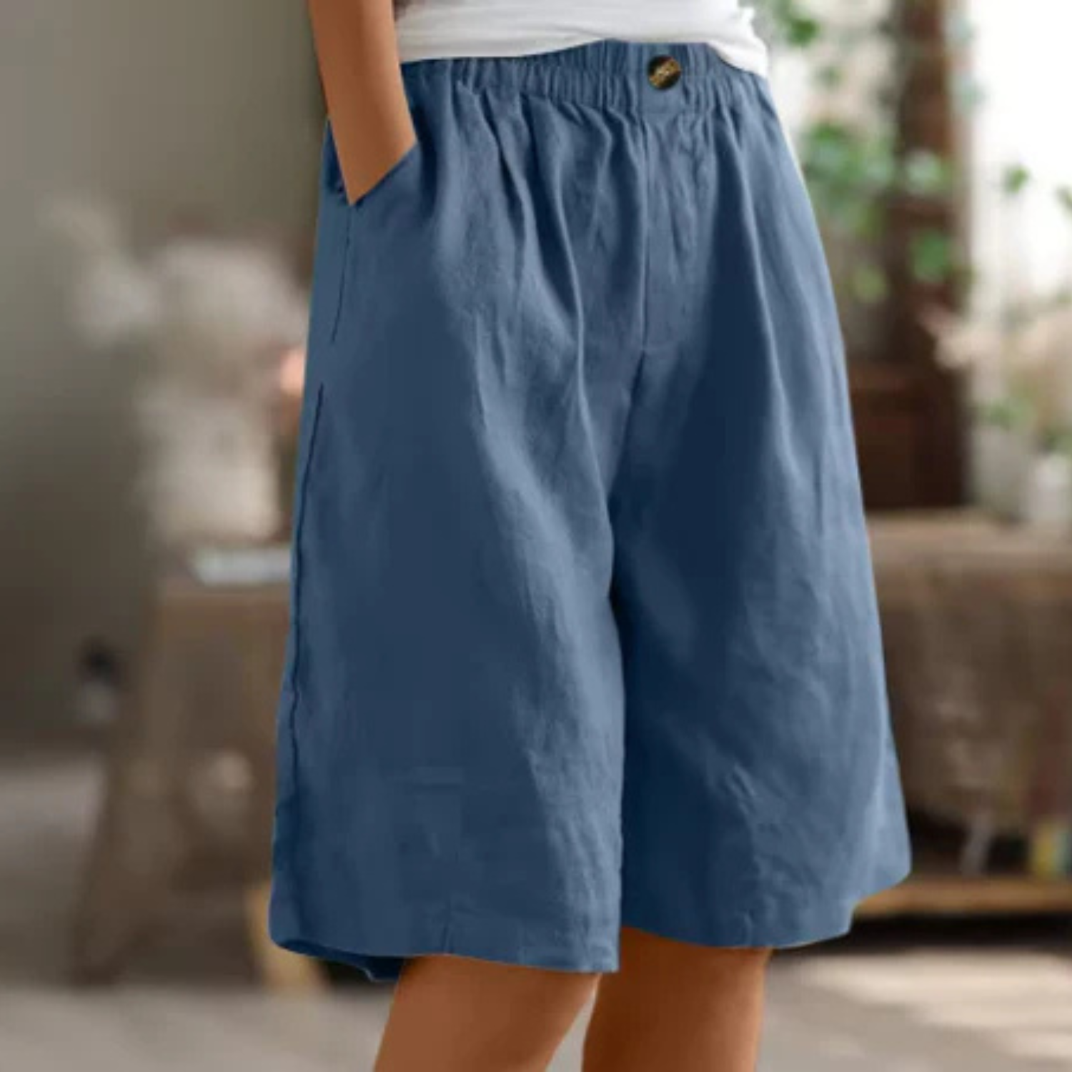 Women's linen blend shorts featuring an elastic waistband, designed for lightweight comfort and casual summer wear, complete with convenient pockets. 3