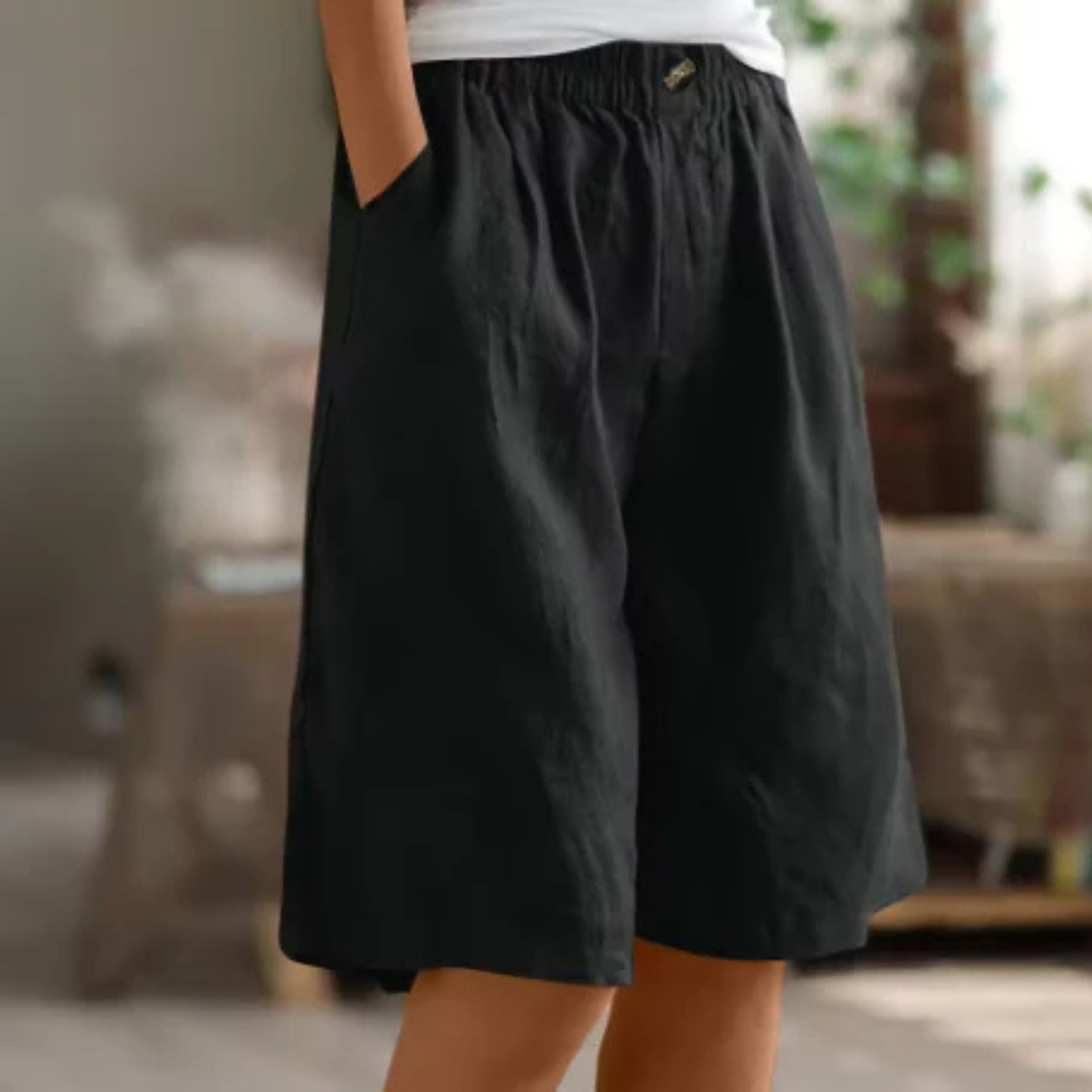 Women's linen blend shorts featuring an elastic waistband, designed for lightweight comfort and casual summer wear, complete with convenient pockets. 8