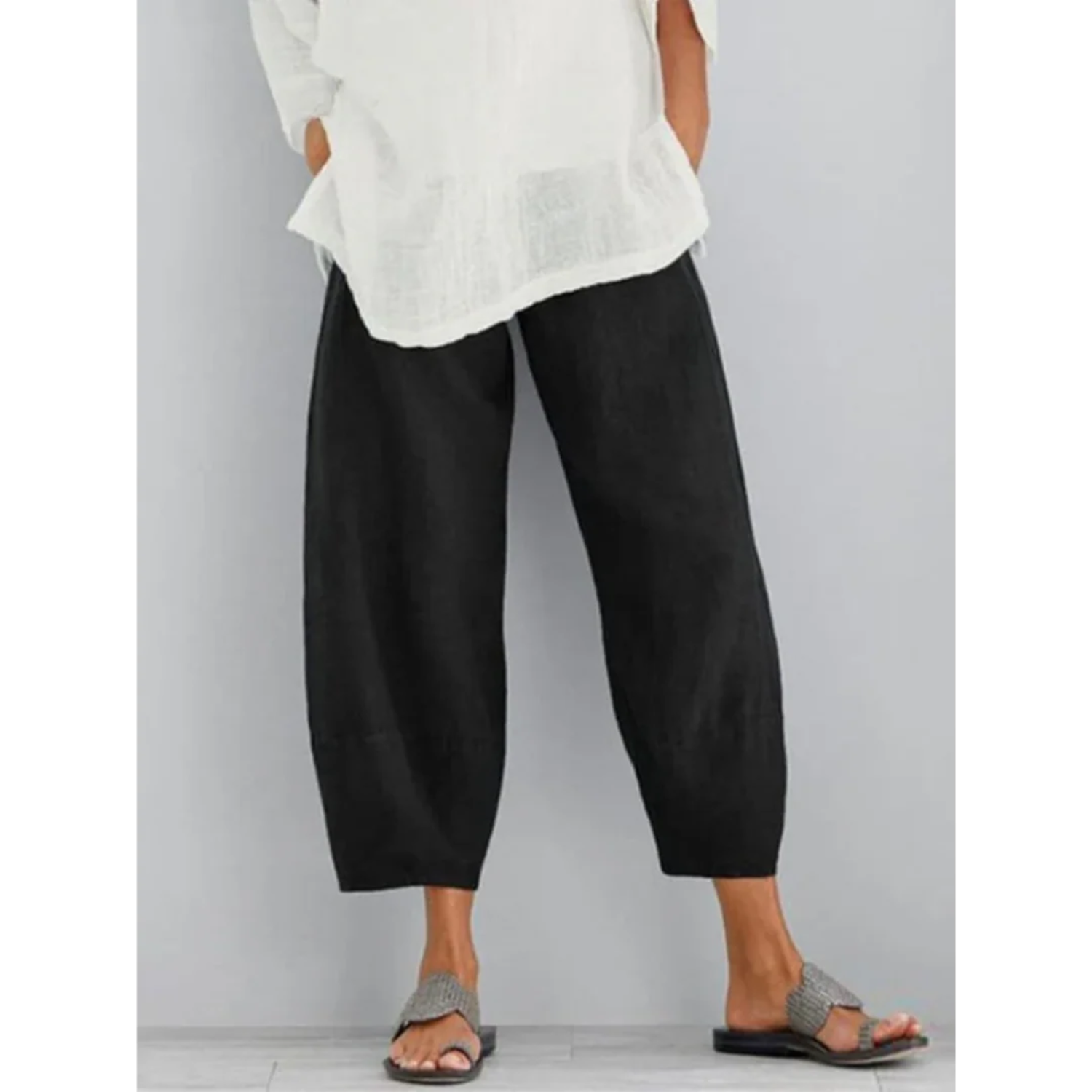 Women's lightweight casual white linen pants featuring an elastic waistband, perfect for summer leisure and comfort. 1