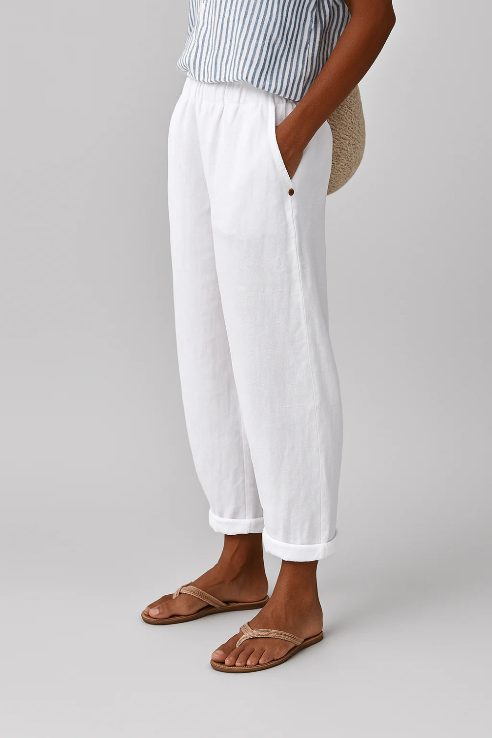 Women's linen pants featuring an elastic waistband and tapered design, perfect for casual wear; breathable and lightweight fabric ideal for warm weather. 5