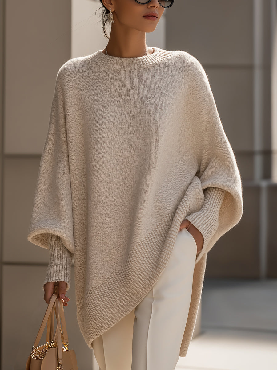 Women's oversized sweater featuring a cozy knit crew neck design and stylish asymmetrical hem, perfect for casual and comfortable outfits. 0