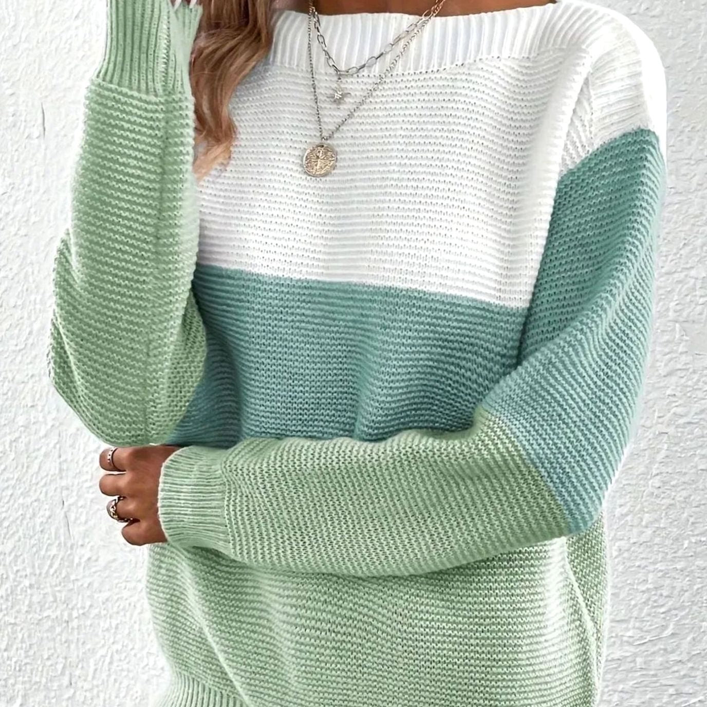 Women's sweater featuring a relaxed fit and boat neckline, designed with a soft color block ribbed knit pattern in pastel shades. 2