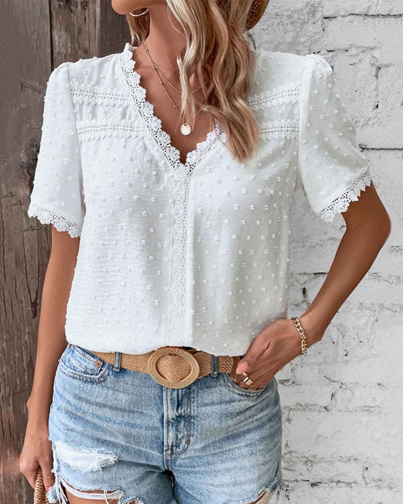 Lightweight women's blouse featuring a lace trim V-neck and Swiss dot texture, perfect for casual summer wear. 1