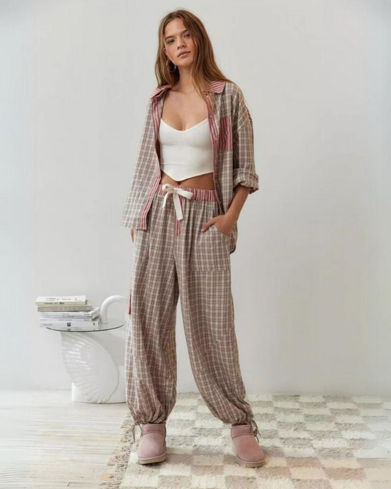 Womens pyjamas set featuring a relaxed fit, made from soft breathable fabric, with full-length trousers available in pink or blue. 1