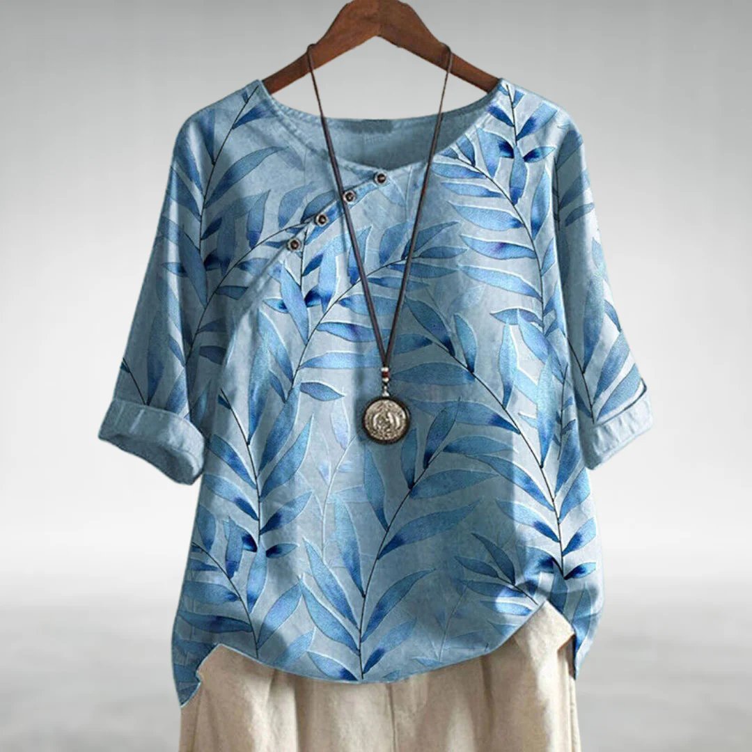 Womens soft blue linen-look short sleeve blouse featuring a relaxed fit and vibrant floral print, perfect for casual summer outings. 0