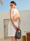 Backless mini dress featuring asymmetrical cutouts and a sleeveless design, made from lightweight cotton-rayon fabric, perfect for party wear. 0