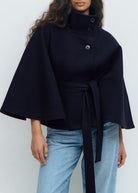 Belted black cape coat with stand collar and button closure, made from wool-style fabric for women, perfect for stylish winter layering. 2