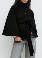 Belted black cape coat with stand collar and button closure, made from wool-style fabric for women, perfect for stylish winter layering. 4