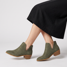 Black ankle boots for women featuring a stylish tasselled back zip, low stacked heel, and elegant V-front design, made from vegan material. 4