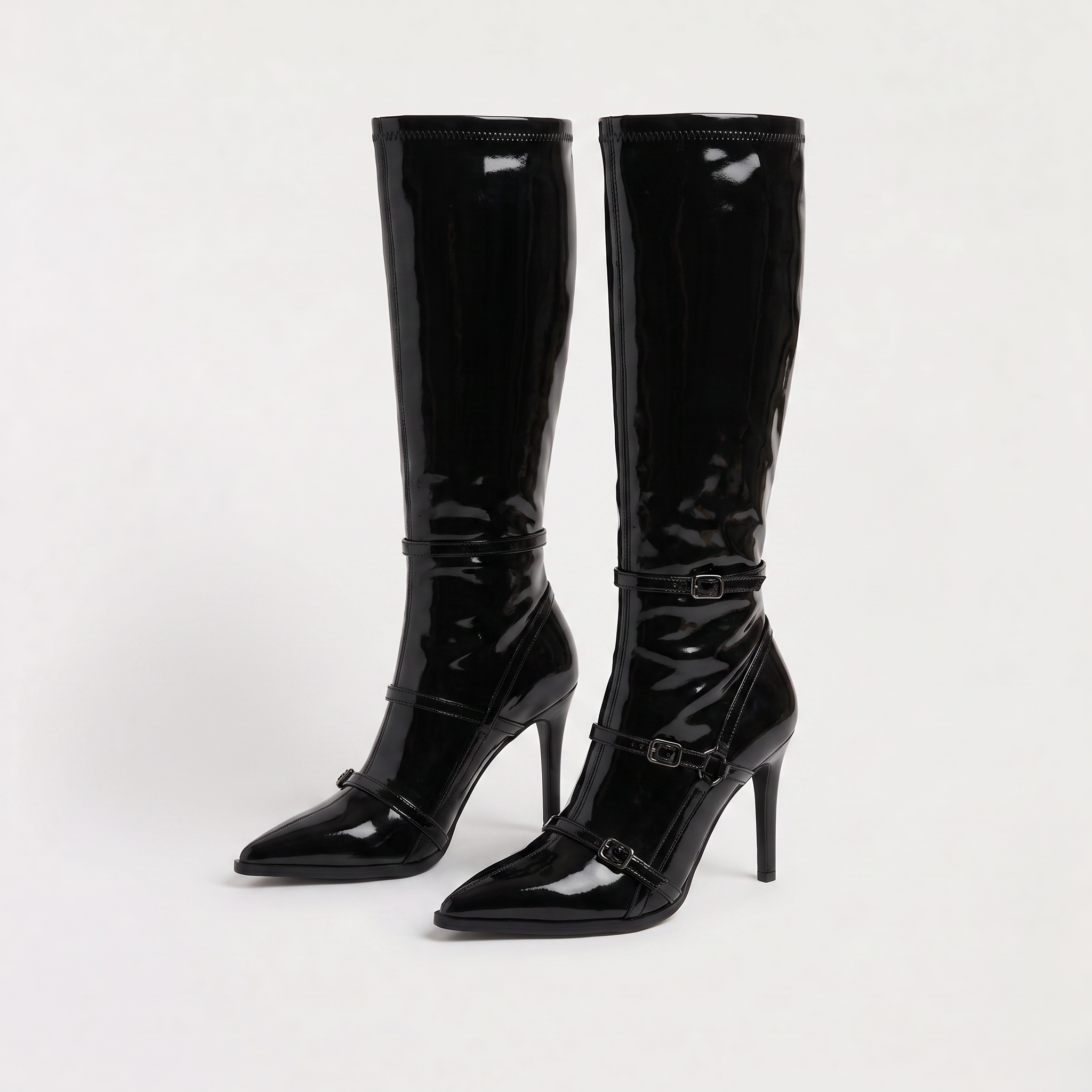 Black knee high boots featuring a sleek patent finish, inner zip closure, and stylish buckled straps, designed with elegant stiletto heels for women. 4