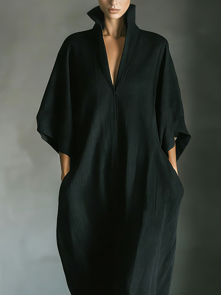 Black maxi dress featuring kimono sleeves and convenient pockets, designed for women in a comfortable oversized cotton blend. 2