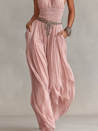 Blush jumpsuit featuring a ruched waist and wide-leg design, showcasing an elegant halter neck style perfect for formal occasions. 3