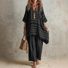 Boho vintage women's outfit featuring a stylish V-neck top and wide leg pants with a chic striped design, perfect for summer holidays. 2