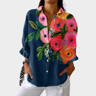 Colorful printed blouse featuring a flowing cut and vibrant floral patterns, ideal lightweight summer top for women. 0