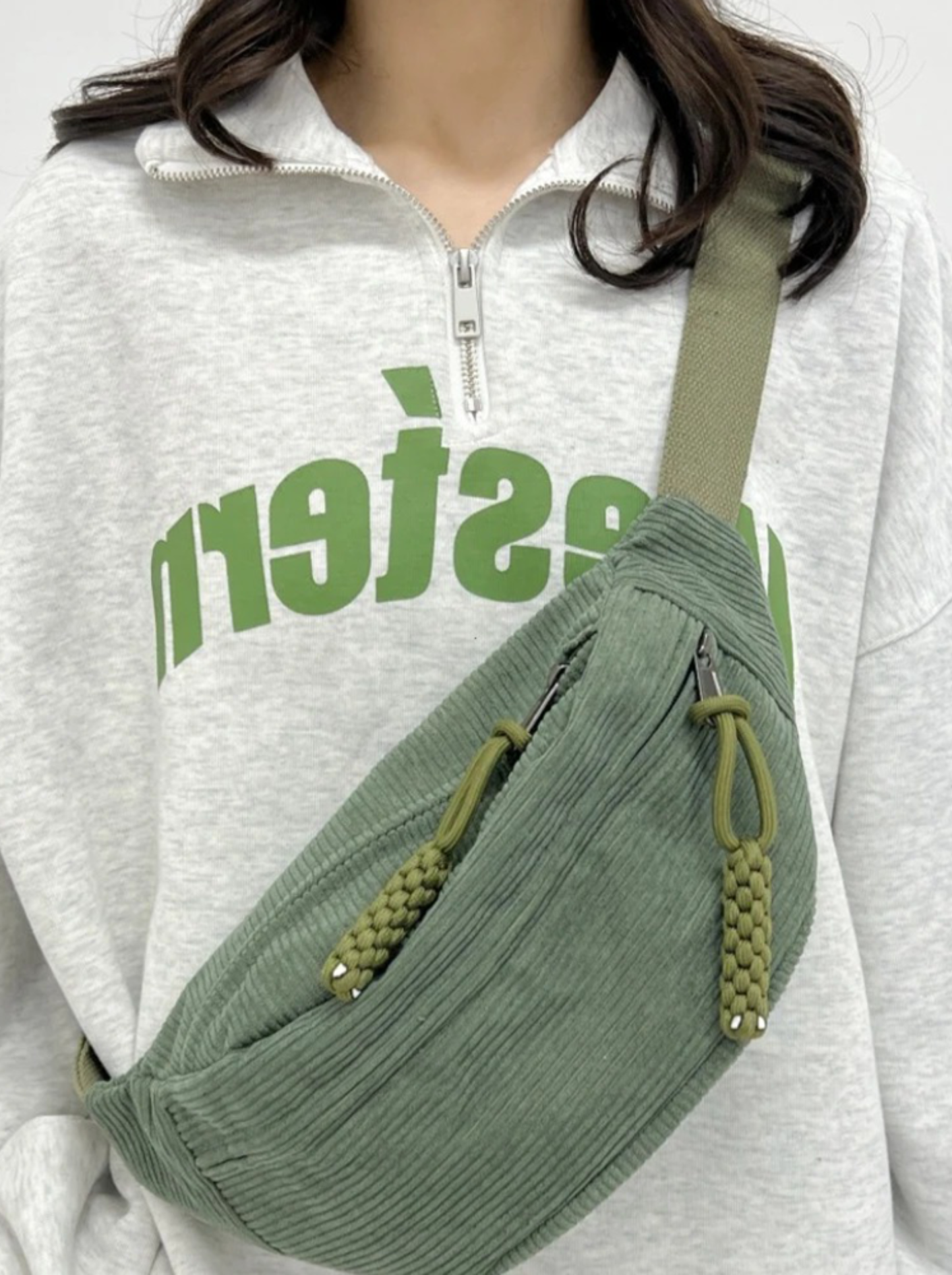 Corduroy crossbody bag in sage green featuring a crescent design and an adjustable strap, perfect for women’s casual style. 0