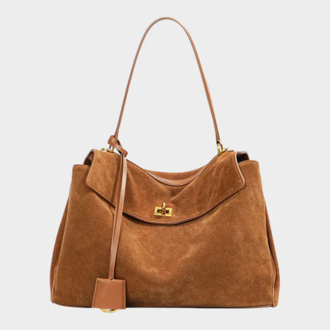 Cowhide leather shoulder bag featuring a magnetic flap closure and an adjustable strap, perfect for everyday use and versatile styling. 1