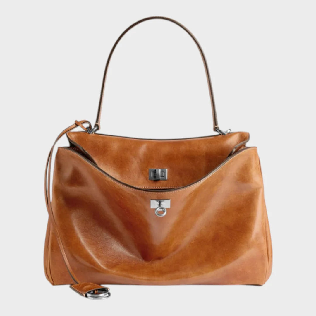 Cowhide leather shoulder bag featuring a magnetic flap closure and an adjustable strap, perfect for everyday use and versatile styling. 9
