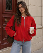 Cropped bomber jacket for women featuring a zip-up front and soft lightweight fleece design, perfect for stylish layering in cool weather. 1
