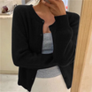 Cropped cardigan sweater for women featuring a button front and round neckline, made from soft cashmere-feel knit for ultimate comfort and style. 1