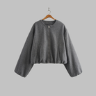 Cropped zip jacket with collarless neckline in soft structured design, perfect for a stylish and modern look. 0