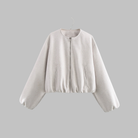 Cropped zip jacket with collarless neckline in soft structured design, perfect for a stylish and modern look. 1