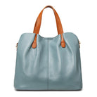 Genuine leather handbag with adjustable strap, featuring luxurious lychee grain cowhide, available in blue, black, pink, gray, and beige, designed 1