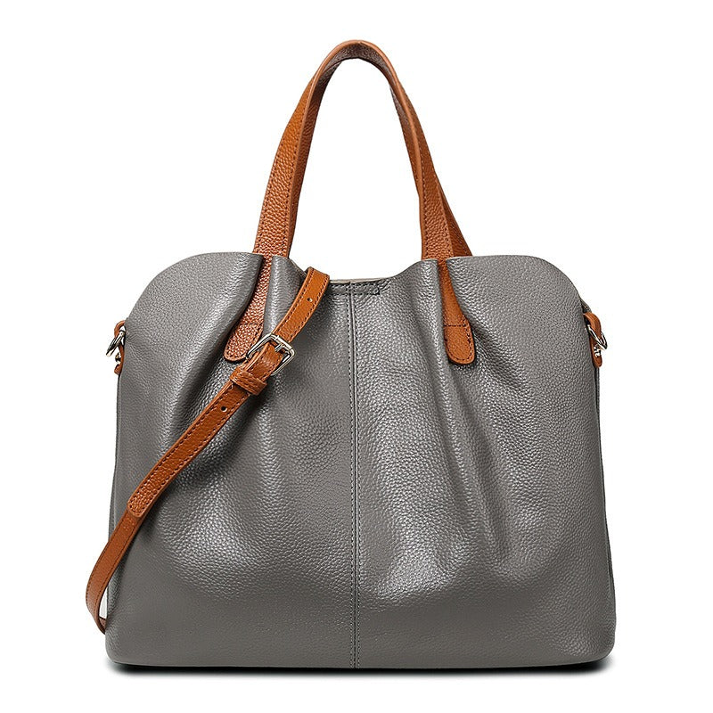 Genuine leather handbag with adjustable strap, featuring luxurious lychee grain cowhide, available in blue, black, pink, gray, and beige, designed 2