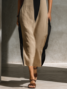 Halter neck midi dress featuring a keyhole cutout in a black and beige cotton blend, designed for an elegant fitted silhouette. 3