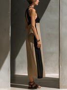 Halter neck midi dress featuring a keyhole cutout in a black and beige cotton blend, designed for an elegant fitted silhouette. 4
