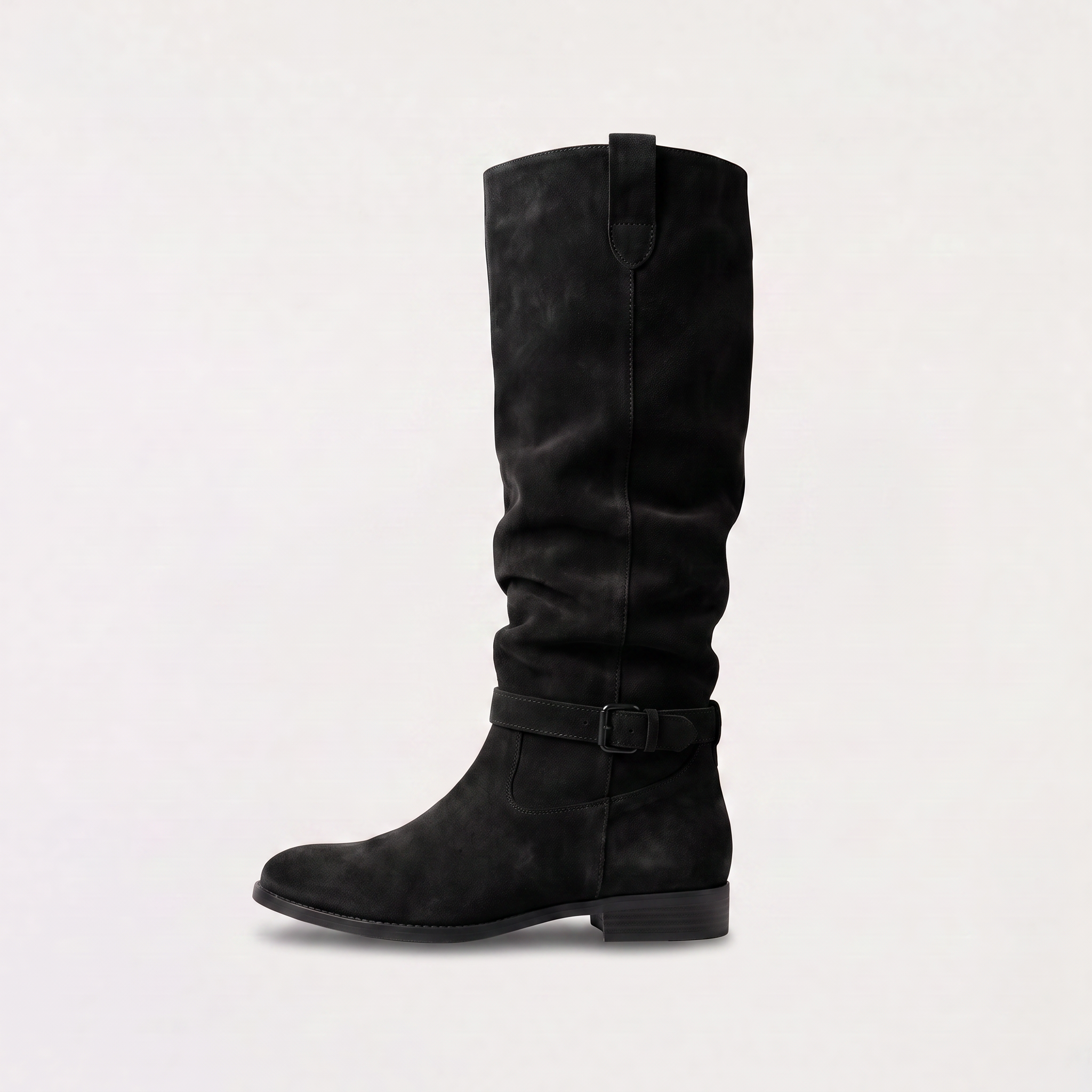 Knee high black boots for women featuring a slouch silhouette and buckled ankle tab, crafted from vegan materials with a low stacked heel. 7