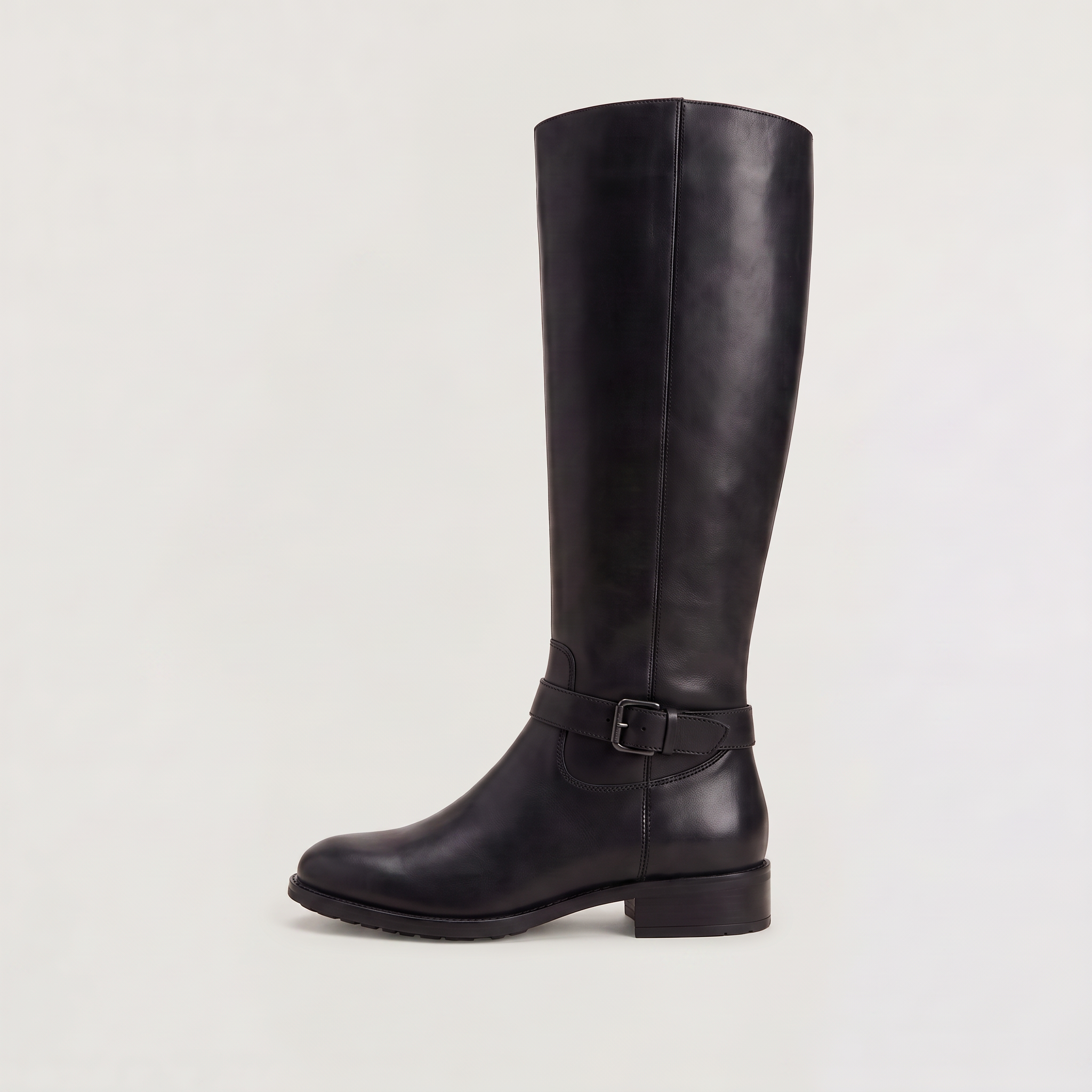 Knee high black riding boots for women with buckled ankle strap, made from faux leather and featuring a low stacked heel. 0