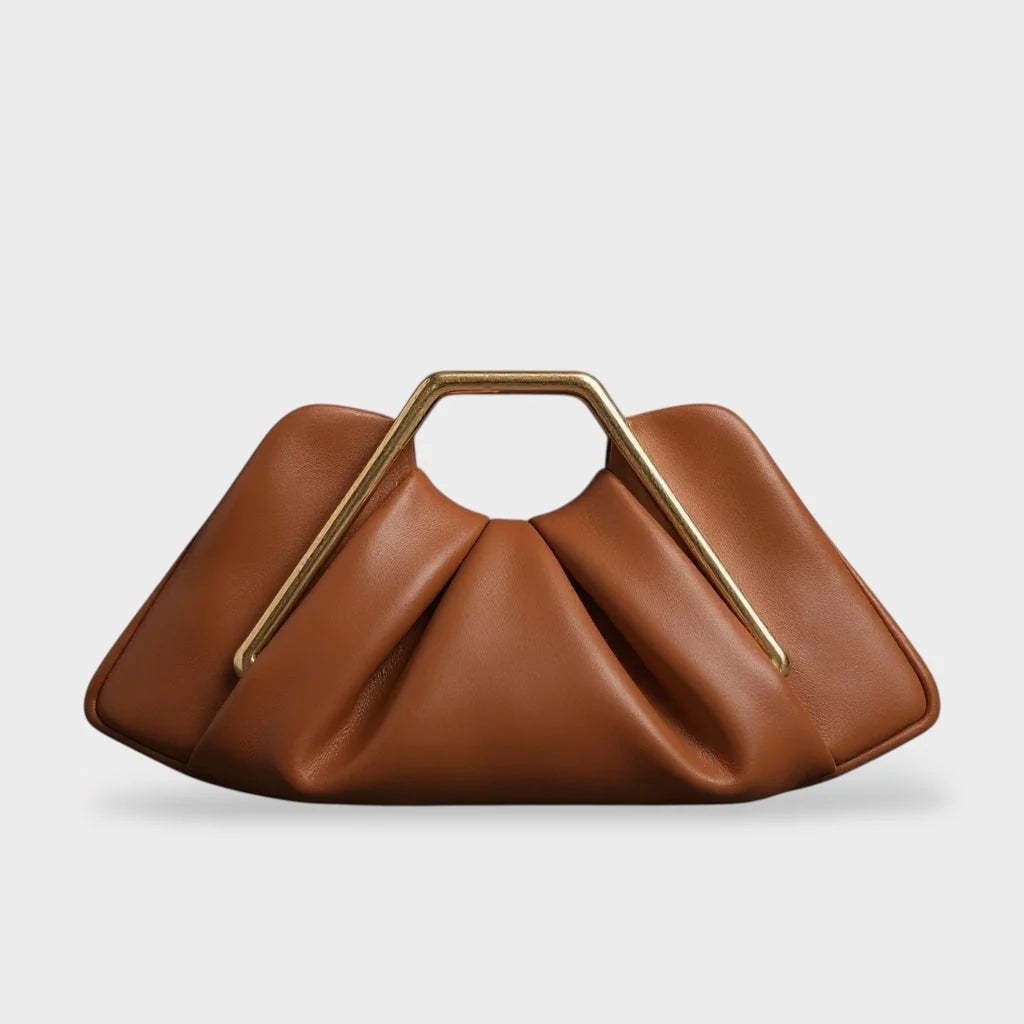 Stylish leather clutch bag featuring a gold handle, origami-inspired design, and a spacious interior made from high-quality microfiber leather. 0