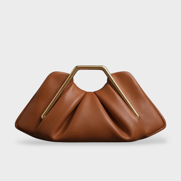 Stylish leather clutch bag featuring a gold handle, origami-inspired design, and a spacious interior made from high-quality microfiber leather. 0
