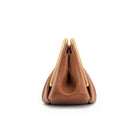 Stylish leather clutch bag featuring a gold handle, origami-inspired design, and a spacious interior made from high-quality microfiber leather. 4