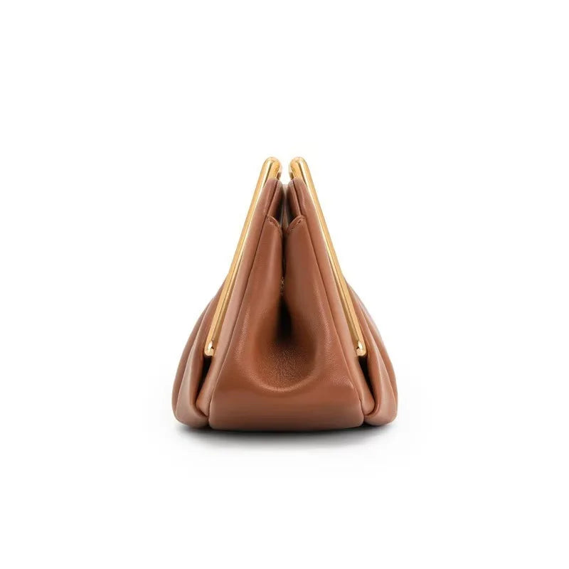 Stylish leather clutch bag featuring a gold handle, origami-inspired design, and a spacious interior made from high-quality microfiber leather. 4